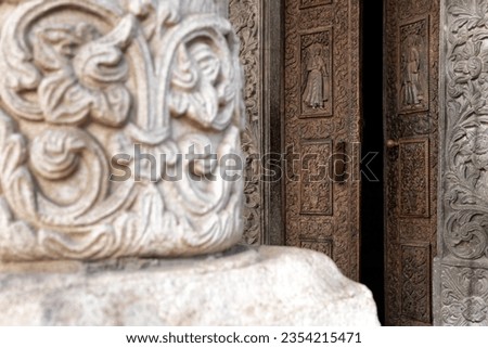 Detail of the entry door behind a column at the Stavropoleos Monastery in the old town of Bucharest, Romania.