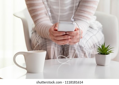 Detail Of Female Hands Holding A Smart Phone, Surfing The Net And Scrolling.