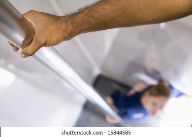 Detail Of A Firefighter Sliding Down The Fireman's Pole