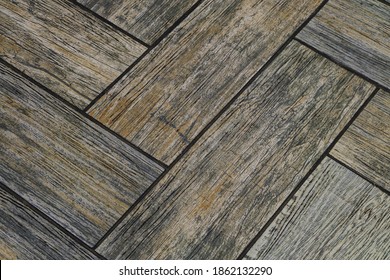 Detail Of Floor Tiles With Embossed Wood Texture. Brown Flooring Close-up.