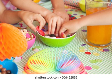 Detail Of Four Children Hands Taking Sweets And Party Food At A Home Garden Birthday Party Having Fun, Outdoors. Kids Celebrating, Eating And Enjoying A Colorful Party On Sunny Day, Lifestyle.