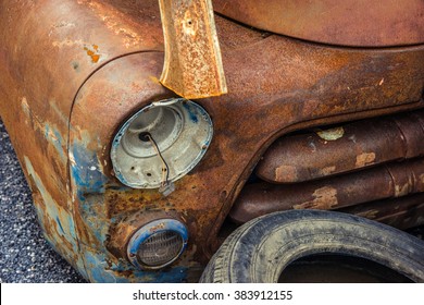 Detail Of The Front Headlight Of An Rusty Car In Garage