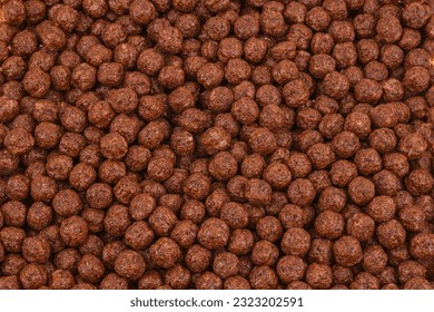 Detail of full frame filled with chocoball cereals. Capture top view. Chocolate corn cereal ball close up brown texture