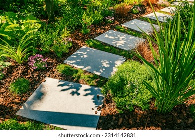 Detail of  garden path with stone slabs with bark mulch and native plants. Landscaping and gardening concept. - Powered by Shutterstock