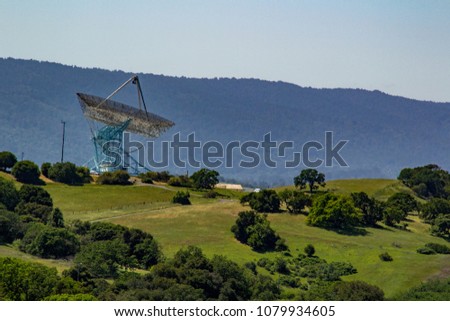 Detail of a giant radio telescope dish pointed skyward.