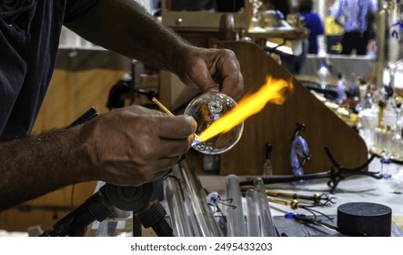 Detail of a glass craftsman, shaping glass with fire - Powered by Shutterstock