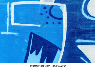 Detail Of A Graffiti Art On A Wall. Wall Painted In Different Colors. Abstract Blue Background.