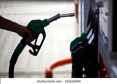 Detail Of A Hand Holding A Fuel Pump At A Station