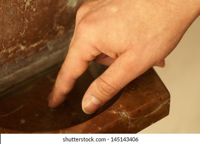 Detail Of Hand And Holy Water Stoup In The Church.