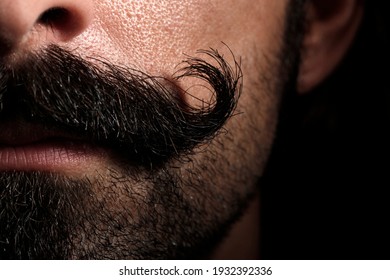 Detail of a "handlebar" mustache of a white man