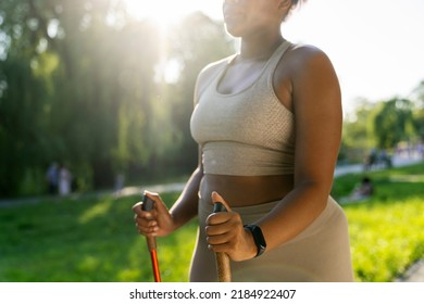 Detail Of Hand's Of African American Woman Exercising Nordic Walking In The Park In The Summer
