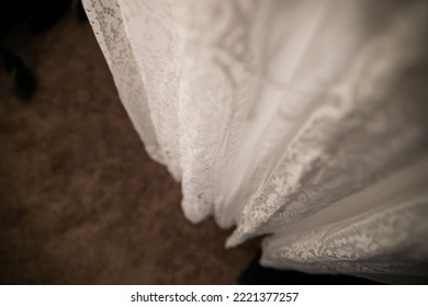 A Detail Of A Hanging Beautiful White Lace Dress