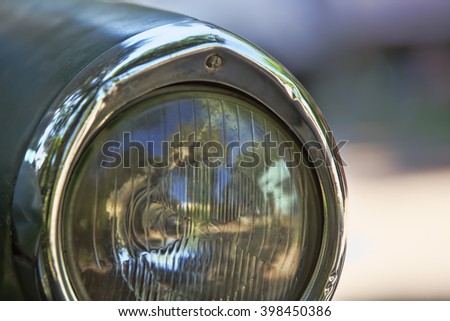 Detail of the headlight of a Peugeot 404