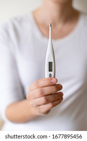 Detail Of Healthy Woman Measuring With A Digital Thermometer High Fever. Keep Control Of Risk Levels Of High Temperature In Our Body During Pandemic Viral Crisis Covid 19. Unrecognizable Nurse.