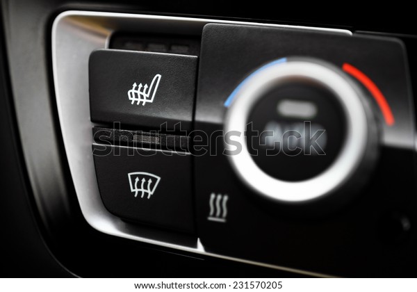 Detail of the heated\
seats button in a car.