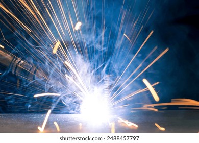 Detail of heavy industry manufacturing, sparks come out of a metal working welder. - Powered by Shutterstock