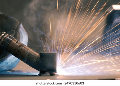 Detail of heavy industry manufacturing, sparks come out of a metal working welder. - Powered by Shutterstock