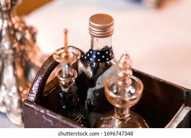 Detail Of A Holy Chrism And Holy Oil In  Glass Bottles Inside Of A Wooden Box During A Baptism Ceremony