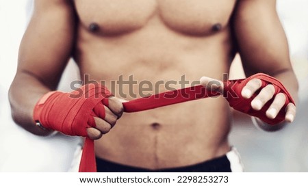 Detail of a human fighting machine. a man strapping his hands and wrists before a fight.