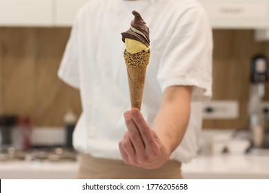 Detail Of An Ice Cream Man Serving Ice Cream Towards The Camera.