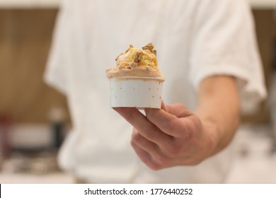 Detail Of An Ice Cream Man Serving Ice Cream Towards The Camera.