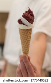 Detail Of An Ice Cream Man Serving Ice Cream Towards The Camera.