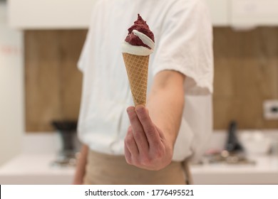 Detail Of An Ice Cream Man Serving Ice Cream Towards The Camera.