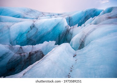 Detail Icelandic glacier image bright blue glacier abstract closeup texture image with black lines from volcanic ash