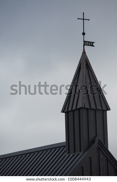 Detail of the\
iconic famous black church in Budir, Snaefellsnes,\
Iceland.Budakirkja christian church.Popular tourist attraction and\
wedding location in north arctic\
circle.