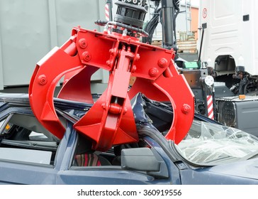 Detail of industrial crane claw grabbing old car for recycling in  car scrap yard. - Powered by Shutterstock