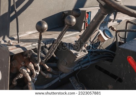 Detail of the interior of an old tractor in an industrial environment.close-up on the levers inside