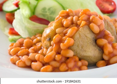 Detail Of A Jacket Potato With Baked Beans And A Out Of Focus Salad.