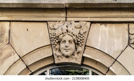 Detail from keystone face and grapes as hair in a archway. - Shutterstock ID 2138008405