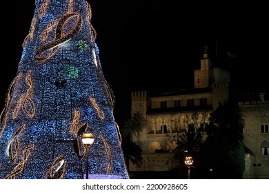 Detail of a large Christmas light tree in front of the "Palau de l'Almudaina", in Palma (Majorca), at night.