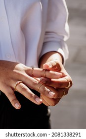 Detail Of Latin Woman's Hands Putting On Gold Rings And Gemstone Rings. Fashion Concept