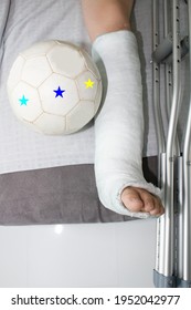 Detail left leg or in white plaster placed and kick ball.Broken leg in plaster. The boy has a broken ankle.