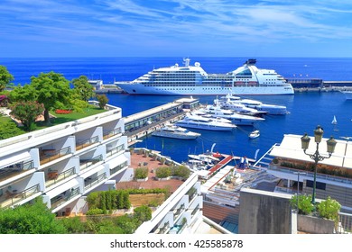 Detail of luxury buildings and distant cruise ship in the harbor of Monaco 