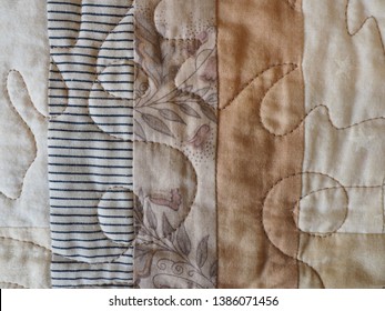 Detail Of Machine Quilting On A Log Cabin Patchwork Quilt In Beige Colors