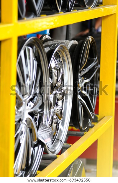 Detail of Magnesium alloy wheel or max wheels of\
car on shelf in a shop.