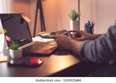 Detail Of Male Hands Scrolling On A Tablet Computer; Man Using Laptop, Tablet And A Smart Phone. Focus On The Index Finger