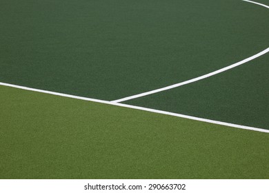 Detail of markings on a synthetic hockey field.