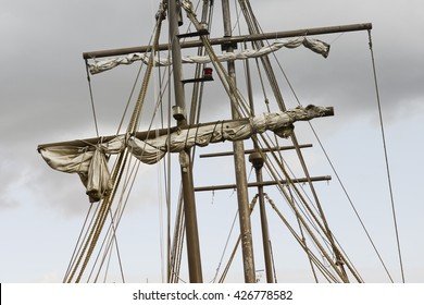Detail of a mast of a ship. Masting of big wooden sailing ship, detailed rigging with sails