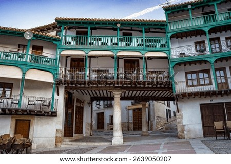 Detail of medieval buildings with green wooden balconies in Chinchon, Madrid, Spain, in the Plaza Mayor
