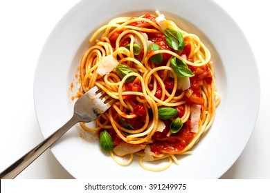 Detail Of Messy Spaghetti With Fork, Tomato Sauce, Basil And Cheese. Isolated On White From Above.