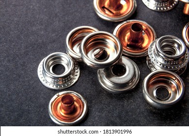 Detail For Metal Buttons For Clothing On Black Background.