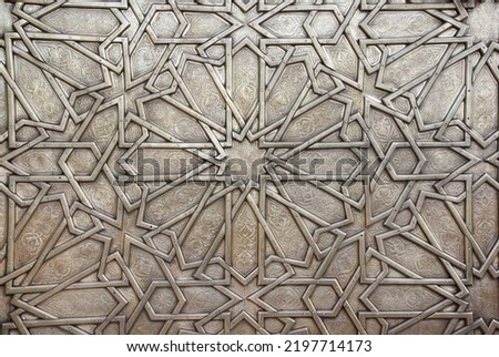 Detail of metal door with traditional islamic ornament. Copper window shutter with antique and national moroccan floral pattern. Oriental ornaments with artistic with chasing for brass