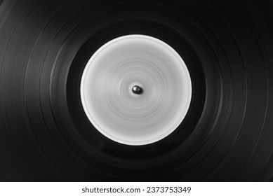 Detail of the microgrooves of an old vinyl record in motion, in black and white - Powered by Shutterstock