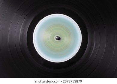Detail of the microgrooves of an old vinyl record in motion - Powered by Shutterstock