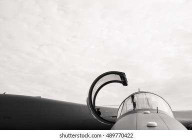 Detail Of Military Fighter Plane From The Front Side - Cockpit Of Airplane Is Open And Prepared For Pilot. Black And White, Copy Space With Large Area Of Cloudy Sky 