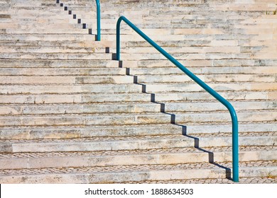 Detail Of A Modern Curved Stone Staircase With Metal Bannister.